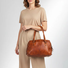 Load image into Gallery viewer, Model carrying the Marlowe cognac Italian leather structured satchel tote over her arm
