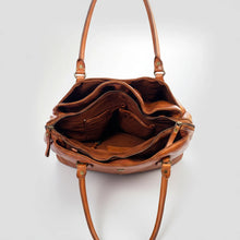 Load image into Gallery viewer, Inside the Marlowe cognac leather satchel showing zip top, divided fabric-lined interior and slip pockets

