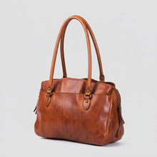 Load image into Gallery viewer, Marlowe cognac Italian leather structured satchel tote, angled view with side zip pocket
