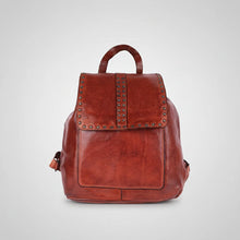 Load image into Gallery viewer, Front view of the Sawyer cognac Italian leather backpack with star-studded flap, studded center stripe, and top handle
