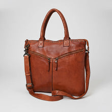Load image into Gallery viewer, Vivienne cognac leather studded zip tote, angled view with rolled handles and detachable crossbody strap
