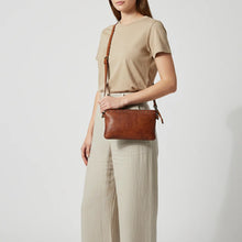 Load image into Gallery viewer, Woman wearing the Santa Rosa studded leather crossbody purse in cognac | Dodi Jo's
