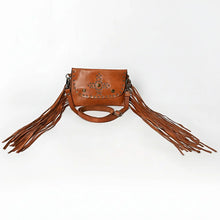 Load image into Gallery viewer, Estrella tan leather fringe crossbody laid flat with long side fringe spread out and the adjustable strap looped below
