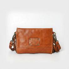 Load image into Gallery viewer, Back view of the Estrella tan leather crossbody showing smooth Italian leather, an embossed logo patch, and swivel strap clasps
