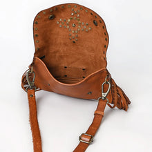 Load image into Gallery viewer, Estrella tan leather crossbody open to show the suede-finish flap underside with its star stud pattern and the interior compartment
