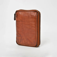 Load image into Gallery viewer, Angled view of the Penny tan zip-around leather wallet showing the slim profile and zipper edge
