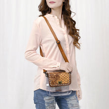 Load image into Gallery viewer, Woman wearing the Trellis clear crossbody purse with quilted hand tooled leather flap and tan leather strap
