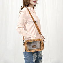 Load image into Gallery viewer, Woman wearing the Window Rock tan leather crossbody with a hand tooled frame around a clear window
