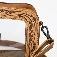 Load image into Gallery viewer, Close-up of the hand tooled scrollwork frame, zip top and black swivel clip on the Window Rock crossbody

