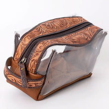 Load image into Gallery viewer, Prairie Bloom hand tooled leather clear toiletry bag with zipper pull and tooled end handle, angled view
