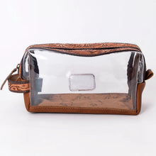 Load image into Gallery viewer, Prairie Bloom clear toiletry bag front view with tooled leather top and leather base
