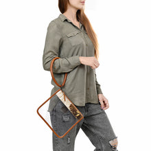 Load image into Gallery viewer, Woman wearing the Gold Dust clear wristlet clutch on her wrist by its rolled leather bangle loop
