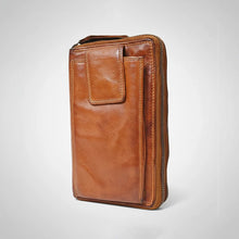 Load image into Gallery viewer, Angled view of cognac vegetable-tanned leather phone wallet with double YKK zippers and front phone pocket
