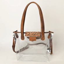 Load image into Gallery viewer, Acorn Ridge clear tote with brown rolled leather handles, leather trim and hand tooled floral flap
