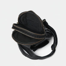Load image into Gallery viewer, Black leather phone crossbody opened to show two fabric-lined zip compartments
