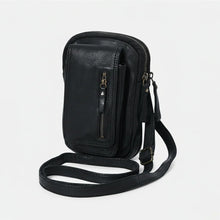 Load image into Gallery viewer, Angled view of black Italian leather phone crossbody with adjustable leather strap
