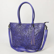 Load image into Gallery viewer, Maple Creek hand tooled leather concealed carry tote in purple, angled view showing floral tooling, tassel and strap
