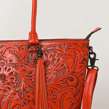 Load image into Gallery viewer, Close-up of Maple Creek red tote showing antiqued hand-tooled florals, fringe tassel and antique brass swivel clip
