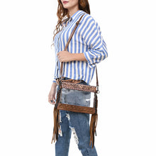 Load image into Gallery viewer, Woman in a striped shirt wearing the Brass Tacks clear fringe crossbody purse in Brown
