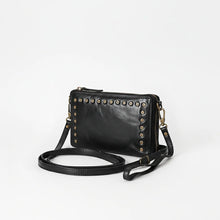 Load image into Gallery viewer, Angled view of black studded Italian leather organizer crossbody with adjustable strap
