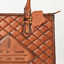 Load image into Gallery viewer, Close-up of Hattie tote diamond quilting, boot-stitch panel and brass handle hardware
