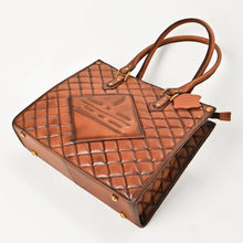 Load image into Gallery viewer, Hattie quilted leather tote from above, showing boot-stitch panel and brass base feet
