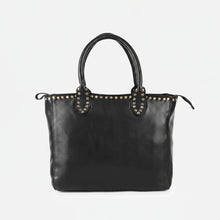 Load image into Gallery viewer, Starla studded leather tote in black, front view with rolled handles, zip top and antique brass stud trim
