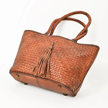 Load image into Gallery viewer, Saffron woven leather tote showing smooth leather base with metal feet
