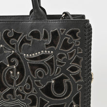 Load image into Gallery viewer, Close-up of Sable tote cutout leather, silver studs, contrast stitching and braided edge
