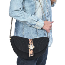 Load image into Gallery viewer, Sundown black suede crescent crossbody worn with denim, close view
