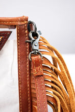 Load image into Gallery viewer, Side detail of the Saguaro Sunrise clear crossbody with leather trim, swivel clip and tan leather fringe
