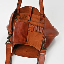 Load image into Gallery viewer, Inside the Amber leather tote showing the raw suede interior and organizer panel with zip pocket, slip pocket and pen loops
