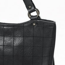 Load image into Gallery viewer, Close-up of the Winslow black leather scored grid, star-stamped rivet and gunmetal handle ring
