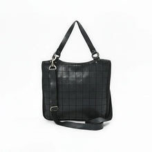 Load image into Gallery viewer, Front of the Winslow black Italian leather grid tote with gunmetal rings and detachable crossbody strap
