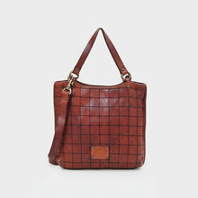 Load image into Gallery viewer, Back of the Winslow cognac Italian leather grid tote with embossed brand plate and crossbody strap
