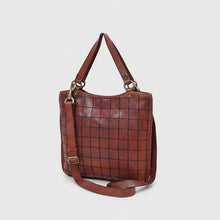 Load image into Gallery viewer, Winslow cognac leather windowpane grid tote, angled view with top handles and crossbody strap
