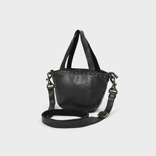 Load image into Gallery viewer, Riva black leather riveted mini tote, angled view with top handles and adjustable strap
