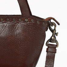 Load image into Gallery viewer, Model holding the Riva dark brown Italian leather riveted mini tote by the top handles
