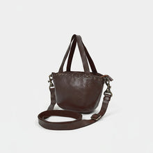 Load image into Gallery viewer, Riva dark brown leather riveted mini tote, angled view with top handles and adjustable strap
