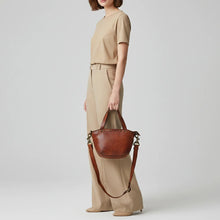 Load image into Gallery viewer, Model carrying the Riva tan Italian leather riveted mini tote with crossbody strap
