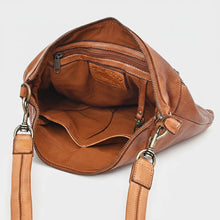 Load image into Gallery viewer, Inside the Tawny tan leather crossbody showing the lined main compartment, interior zip pocket, slip pockets, and key clip

