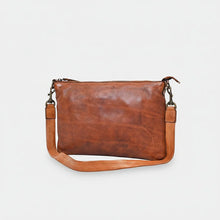 Load image into Gallery viewer, Angled view of the Tawny tan slim Italian leather crossbody with shaded leather, zip top, and detachable strap
