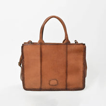 Load image into Gallery viewer, Back of the Solstice tote showing burnished cognac leather panels and braided edges
