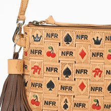 Load image into Gallery viewer, A close-up of a tan woven leather clutch purse featuring a playful topper pattern of playing card suits, cherries, 777 symbols, and 'NFR' text, with a dark brown leather tassel charm.
