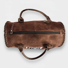 Load image into Gallery viewer, Charmayne brown suede NFR speedy bag with hand-braided edging and 40 years Las Vegas charm
