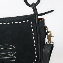 Load image into Gallery viewer, Close-up of the Emilie black suede purse showing white boot stitch embroidery, diamond whipstitch trim and antique brass swivel clasp
