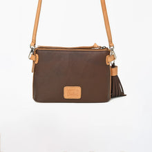 Load image into Gallery viewer, A dark brown pebbled leather crossbody bag with tan leather trim, a matching shoulder strap, and a tassel detail on the side, shown against a plain white background.
