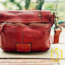 Load image into Gallery viewer, Close-up of the Washoe Lake crossbody back zip pocket, brass zipper, and stitched leather detail
