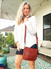 Load image into Gallery viewer, Washoe Lake studded leather crossbody purse worn crossbody by a model
