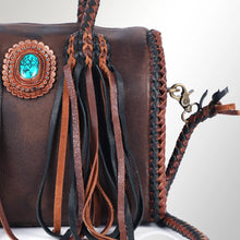Load image into Gallery viewer, Close-up of the Reata satchel in Espresso &amp; Black: turquoise stone in a dotted tooled rosette with black, brown, and cognac fringe
